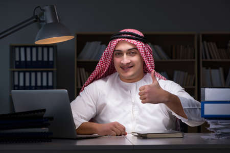 Arab businessman working late in officeの写真素材