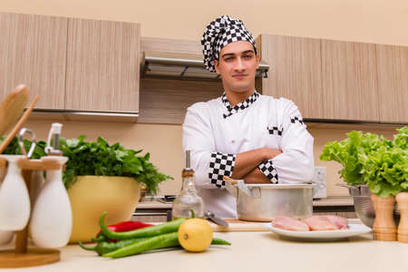 Young chef working in the kitchenの写真素材