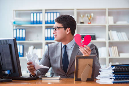 Businessman in saint valentine concept in officeの写真素材