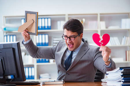 Businessman in saint valentine concept in officeの写真素材