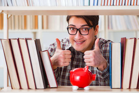 Young student in expensive textbooks conceptの写真素材