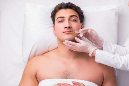 Handsome man in spa massage conceptの写真素材