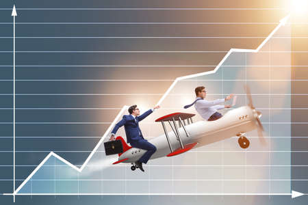 Businessman flying on vintage old airplaneの写真素材