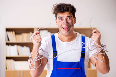 Funny Man doing electrical repairs at home