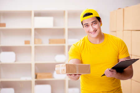 Man working in postal parcel delivery service officeの写真素材