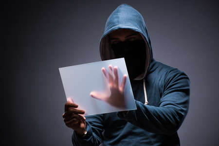 Hacker working on tablet in dark