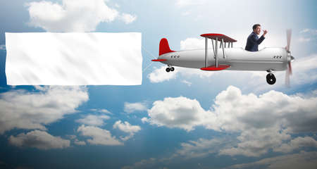 Biplane with businessman and blank bannerの写真素材