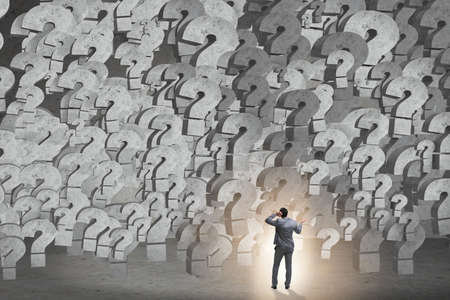 Businessman facing questions in businessの写真素材