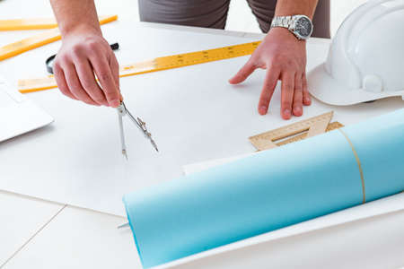 Male engineer working on drawings and blueprints