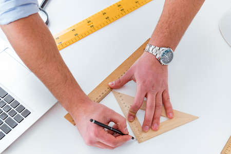 Male engineer working on drawings and blueprints