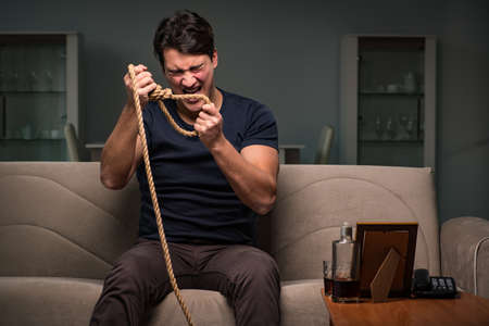 Depressed man holding a noose