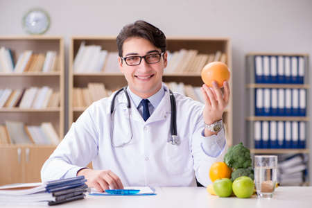 Doctor in dieting concept with fruits and vegetablesの写真素材