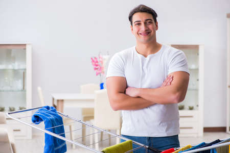 Man doing laundry at homeの写真素材