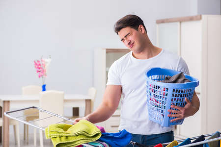 Man doing laundry at homeの写真素材