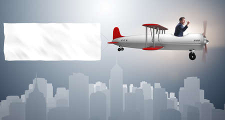 Biplane with businessman and blank bannerの写真素材