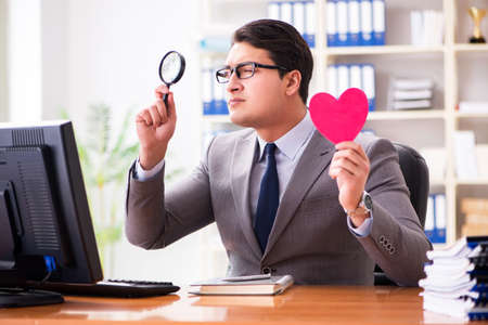 Businessman in saint valentine concept in officeの写真素材