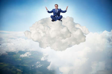 Businessman sitting at top cloud