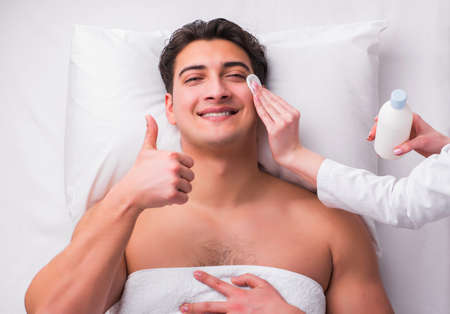 Handsome man in spa massage concept