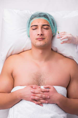 Handsome man in spa massage conceptの写真素材