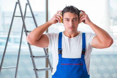 Worker with noise cancelling headphones