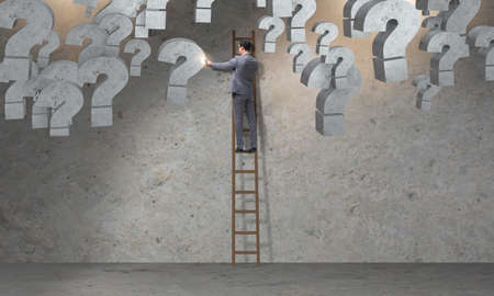 Businessman facing questions in businessの写真素材