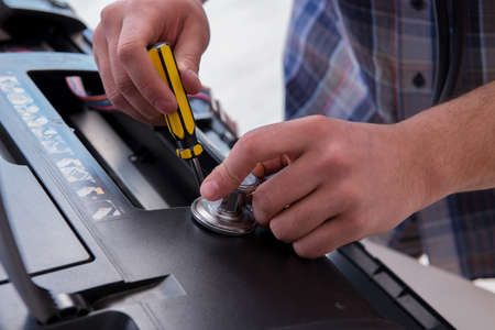 Repairman repairing broken color printerの写真素材