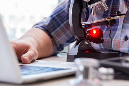 High precision engineering with man working with microscope