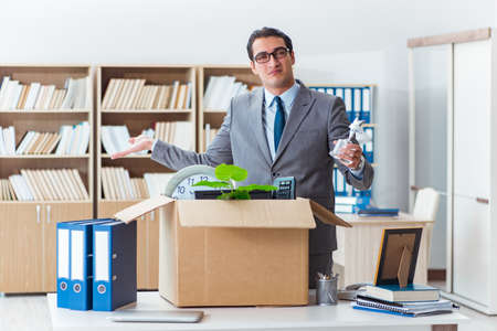 Man moving office with box and his belongingsの写真素材