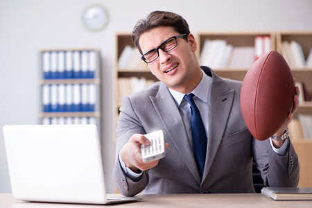 Businessman with american football in office