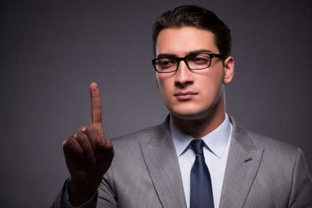Handsome businessman pressing virtual buttonsの写真素材