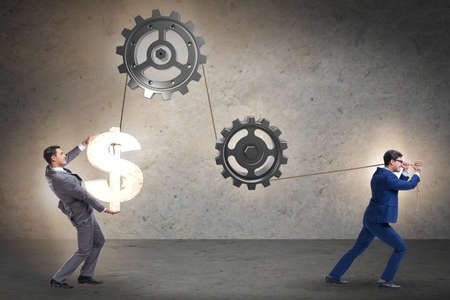 Businessman pulling mechanism and raising dollarの写真素材