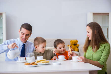 Happy family having breakfast together at homeの写真素材