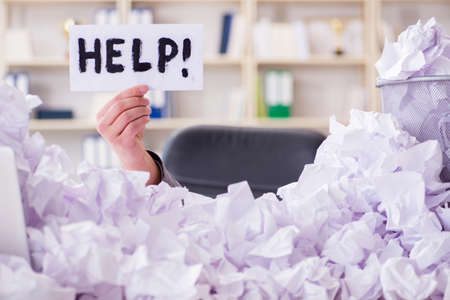Businessman in paper recycling concept in office