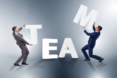 Teamwork concept with businessman putting lettersの写真素材