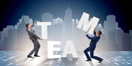 Teamwork concept with businessman putting lettersの写真素材