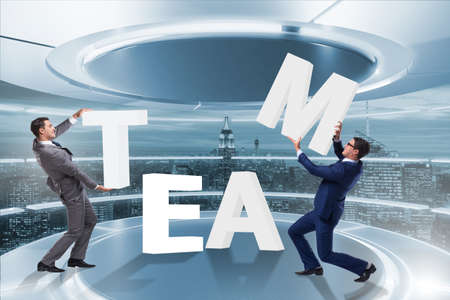 Teamwork concept with businessman putting lettersの写真素材