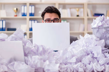 Businessman in paper recycling concept in office
