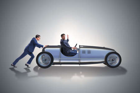 Businessman car pushing in teamwork conceptの写真素材