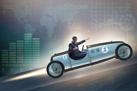 Businessman riding sports car against charts