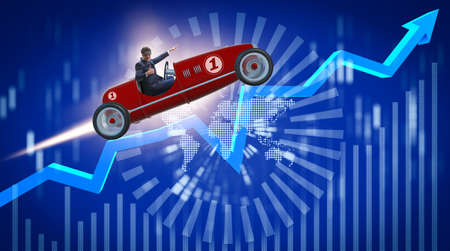 Businessman riding sports car against chartsの写真素材