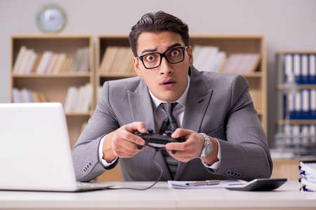 Businessman playing computer games at work office