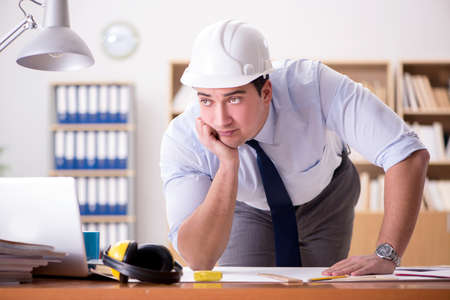 Engineer supervisor working on drawings in the office