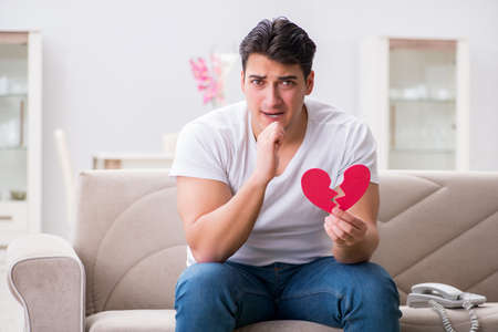 Young man in sad saint valentine conceptの写真素材