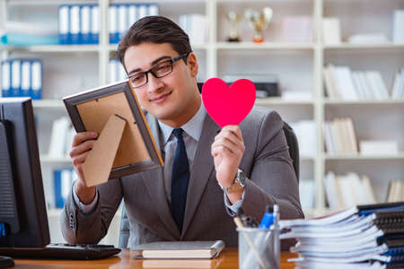 Businessman feeling love and loved in the officeの写真素材