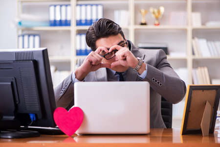 Businessman in saint valentine concept in officeの写真素材