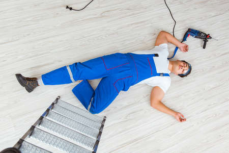 Worker after falling from height - unsafe behaviorの写真素材