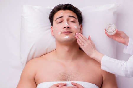 Handsome man in spa massage conceptの写真素材