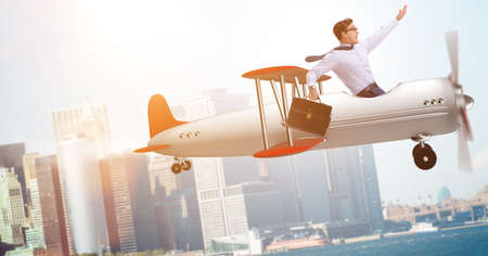 Businessman flying on vintage old airplaneの写真素材