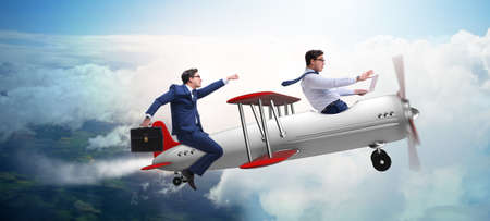 Businessman flying on vintage old airplaneの写真素材