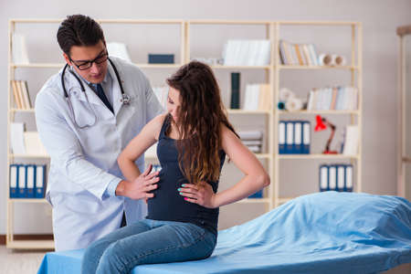 Doctor examining pregnant woman patientの写真素材